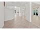 Bright foyer featuring tile flooring, an elegant curved staircase, and decorative columns at 253 White Willow Ave, Las Vegas, NV 89123