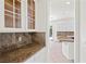 Kitchen area featuring granite countertops and white cabinetry at 253 White Willow Ave, Las Vegas, NV 89123