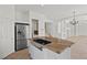 Modern kitchen island with granite countertop and stainless steel appliances at 253 White Willow Ave, Las Vegas, NV 89123
