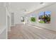 Spacious living room with wood floors, recessed lighting, and large windows overlooking the lush yard at 253 White Willow Ave, Las Vegas, NV 89123