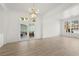 Open living room featuring hardwood floors, chandelier, and sliding doors at 253 White Willow Ave, Las Vegas, NV 89123