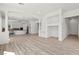 Bright open-concept living space with wood floors, recessed lighting, built-in shelving, and a view to the kitchen at 253 White Willow Ave, Las Vegas, NV 89123