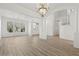 Bright and airy living room with luxury vinyl plank and a view of the foyer at 253 White Willow Ave, Las Vegas, NV 89123