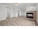 Open-concept living room featuring a fireplace and wood-look floors at 253 White Willow Ave, Las Vegas, NV 89123
