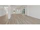 Spacious living room features new wood flooring, chandelier, and large sliding doors at 253 White Willow Ave, Las Vegas, NV 89123