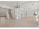 Elegant living room featuring a staircase, chandelier, and built-in shelving at 253 White Willow Ave, Las Vegas, NV 89123