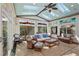 Sunroom seating area with stained glass windows and ceiling fan at 253 White Willow Ave, Las Vegas, NV 89123