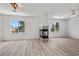 Bright living room with a tile fireplace, wood-look floors, and natural light at 253 White Willow Ave, Las Vegas, NV 89123