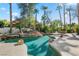 Stunning backyard pool, rock waterfall, lush landscaping and built in grill at 253 White Willow Ave, Las Vegas, NV 89123