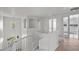 Open staircase landing with white railings and tile flooring at 253 White Willow Ave, Las Vegas, NV 89123