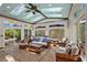 Bright sunroom featuring a custom ceiling, stained glass windows, and comfortable wicker furniture at 253 White Willow Ave, Las Vegas, NV 89123