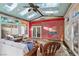 Bright sunroom featuring a custom ceiling, stained glass windows, and comfortable wicker furniture at 253 White Willow Ave, Las Vegas, NV 89123