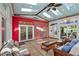 Bright sunroom featuring a custom ceiling, stained glass windows, and comfortable wicker furniture at 253 White Willow Ave, Las Vegas, NV 89123