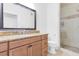 Bathroom featuring granite countertop, framed mirror, and shower with neutral tile at 2615 W Gary Ave # 1041, Las Vegas, NV 89123