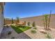 A well-maintained backyard with gravel and a central square of green turf around an outdoor dining set at 2633 Begonia Falls Ave # 88, North Las Vegas, NV 89081