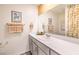 A stylish bathroom featuring modern vanity, neutral countertop, decorative mirror, and attractive accessories at 2633 Begonia Falls Ave # 88, North Las Vegas, NV 89081