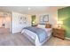 This bedroom features carpet, an ensuite bathroom, and stylish decor for a restful retreat at 2633 Begonia Falls Ave # 88, North Las Vegas, NV 89081