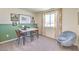 Bright room with work space, large window with curtains, comfortable chair, and modern decor at 2633 Begonia Falls Ave # 88, North Las Vegas, NV 89081