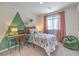 Fun bedroom with a dinosaur theme, featuring colorful decor, desk, and comfortable beanbag chair at 2633 Begonia Falls Ave # 88, North Las Vegas, NV 89081