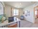 Bright room with work space, large window with curtains, comfortable chair, and modern decor at 2633 Begonia Falls Ave # 88, North Las Vegas, NV 89081