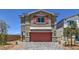 Charming two-story home features a red garage door, matching shutters, and stylish brick driveway at 2633 Begonia Falls Ave # 88, North Las Vegas, NV 89081