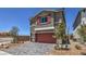 Charming two-story home features a red garage door, matching shutters, and stylish brick driveway at 2633 Begonia Falls Ave # 88, North Las Vegas, NV 89081