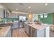 Modern kitchen with stainless appliances, center island with seating, and stylish gray cabinets at 2633 Begonia Falls Ave # 88, North Las Vegas, NV 89081