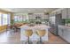 Modern kitchen with gray cabinetry, stainless steel appliances, island with barstool seating, and stylish decor at 2633 Begonia Falls Ave # 88, North Las Vegas, NV 89081