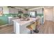 Bright kitchen featuring modern appliances, stylish island with barstool seating, and sleek countertops at 2633 Begonia Falls Ave # 88, North Las Vegas, NV 89081