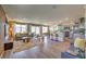 Open-concept living room with modern decor, wood-look floors, and a view of the backyard at 2633 Begonia Falls Ave # 88, North Las Vegas, NV 89081