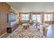 Stylish living room with natural light, wood-look floors, and a textured accent wall with shelving at 2633 Begonia Falls Ave # 88, North Las Vegas, NV 89081