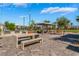 Community BBQ area featuring concrete benches, tables, and well-maintained landscaping at 2691 Mango Light Ave, North Las Vegas, NV 89086
