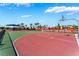 Community basketball court with palm trees, sports equipment, and surrounding landscaping at 2691 Mango Light Ave, North Las Vegas, NV 89086