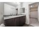Bathroom featuring a double vanity, and neutral colored cabinets at 2691 Mango Light Ave, North Las Vegas, NV 89086