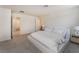 Bright bedroom with neutral carpeting, furniture, and a connected bathroom at 2691 Mango Light Ave, North Las Vegas, NV 89086