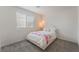 Bright bedroom with neutral carpeting, furniture, and a window at 2691 Mango Light Ave, North Las Vegas, NV 89086