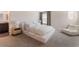 Bright bedroom with neutral carpeting, furniture, and a connected bathroom at 2691 Mango Light Ave, North Las Vegas, NV 89086