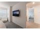 Bright bedroom with neutral carpeting, television, and doorway at 2691 Mango Light Ave, North Las Vegas, NV 89086