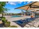 Community pool with lounge chairs, umbrellas, and well-maintained landscaping at 2691 Mango Light Ave, North Las Vegas, NV 89086