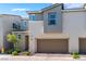 Modern townhouse exterior featuring a two-car garage and well-maintained landscaping at 2691 Mango Light Ave, North Las Vegas, NV 89086