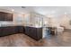 Open-concept kitchen with stainless appliances, granite countertops, and seamless flow to the living area at 2691 Mango Light Ave, North Las Vegas, NV 89086