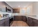 Well-equipped kitchen with modern appliances, granite countertops, and dark wood cabinetry at 2691 Mango Light Ave, North Las Vegas, NV 89086