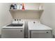 Laundry room features modern, efficient Samsung washer and dryer with storage shelf at 2691 Mango Light Ave, North Las Vegas, NV 89086