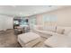 Open-concept living area with modern furnishings, wood-look floors, and a sliding door to the patio at 2691 Mango Light Ave, North Las Vegas, NV 89086