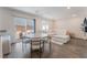 Stylish living area and dining table leading to outdoor patio with comfortable seating at 2691 Mango Light Ave, North Las Vegas, NV 89086