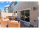 Cozy patio with wicker furniture, fire pit table, and sliding door access to the home at 2691 Mango Light Ave, North Las Vegas, NV 89086