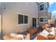Backyard patio with wicker furniture, brick pavers, and privacy walls perfect for entertaining at 2691 Mango Light Ave, North Las Vegas, NV 89086