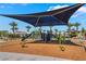 Community playground with slides, climbing structures, and swings on a wood chip ground at 2691 Mango Light Ave, North Las Vegas, NV 89086