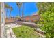 Fenced backyard with a small patio area, landscaping, and a block wall at 2753 Port Of Call Dr, Las Vegas, NV 89128