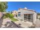 View of the backyard with sliding glass doors and lush landscaping at 2753 Port Of Call Dr, Las Vegas, NV 89128